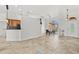 Open-concept living room with tile flooring, arch window, and a view to a kitchen area at 6805 225Th E St, Bradenton, FL 34211
