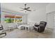 Comfortable living room with a plush sofa, a recliner, and a large window with a trellised porch view at 6805 225Th E St, Bradenton, FL 34211