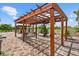 Paver patio with a wood pergola, lighting, and seating at 6805 225Th E St, Bradenton, FL 34211
