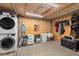 Storage room featuring a washer, dryer, folding chairs, and cleaning supplies at 6805 225Th E St, Bradenton, FL 34211