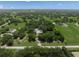 Lush acreage featuring a well-maintained home site shaded by mature trees in a tranquil setting at 7343 Palomino Trl, Sarasota, FL 34241