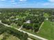 Expansive aerial view of a lush property with mature trees and a well-maintained home site at 7343 Palomino Trl, Sarasota, FL 34241