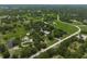 Sprawling acreage showcasing a beautiful property with mature trees, lush greenery, and a well-defined boundary at 7343 Palomino Trl, Sarasota, FL 34241