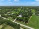 Expansive aerial view of a lush property with mature trees and a well-maintained home site at 7343 Palomino Trl, Sarasota, FL 34241