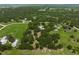 Spacious property featuring a lush setting and peaceful tranquility in this park-like aerial view at 7343 Palomino Trl, Sarasota, FL 34241