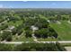 Expansive property featuring a lush green landscape with mature trees and a charming home, fully fenced at 7343 Palomino Trl, Sarasota, FL 34241