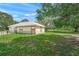 Charming barn with wooden doors nestled among lush greenery and open space on a sunny day at 7343 Palomino Trl, Sarasota, FL 34241
