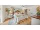 Cozy bedroom with hardwood floors, a ceiling fan, a large rug, and lots of natural light at 7343 Palomino Trl, Sarasota, FL 34241