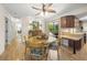Cozy dining area featuring a wooden table with four chairs, slider to patio, and a ceiling fan at 7343 Palomino Trl, Sarasota, FL 34241