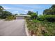 Inviting single-story home with a well-manicured lawn, mature trees, and an attached two car garage at 7343 Palomino Trl, Sarasota, FL 34241