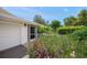 Charming home exterior featuring a white picket fence, lush garden, and a cozy, welcoming entrance at 7343 Palomino Trl, Sarasota, FL 34241