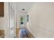 Bright hallway featuring hardwood floors, closet, and a door leading to the outside, creating a seamless transition at 7343 Palomino Trl, Sarasota, FL 34241