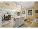 Bright kitchen island featuring a sink and storage, with an adjacent living area at 7343 Palomino Trl, Sarasota, FL 34241