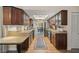 Traditional kitchen featuring wood cabinets, sleek appliances, and an inviting view into the dining room at 7343 Palomino Trl, Sarasota, FL 34241