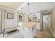 Galley kitchen with white cabinets, an island, stainless appliances, and breakfast bar seating at 7343 Palomino Trl, Sarasota, FL 34241
