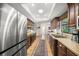 Traditional kitchen with stainless steel refrigerator, wood cabinets and hardwood floor at 7343 Palomino Trl, Sarasota, FL 34241