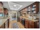 Functional kitchen featuring wood cabinets, stainless steel appliances, and an inviting view into the dining area at 7343 Palomino Trl, Sarasota, FL 34241