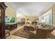 Open-concept living room featuring a bay window, fireplace, and tile floors at 7343 Palomino Trl, Sarasota, FL 34241