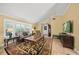 Comfortable living room featuring a large window, hardwood floors and a leather sofa at 7343 Palomino Trl, Sarasota, FL 34241