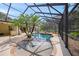 Beautiful screened-in pool with lush landscaping and ample patio space, ideal for outdoor relaxation at 7343 Palomino Trl, Sarasota, FL 34241