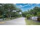 Street view featuring mature trees and landscaping, showcasing the inviting entrance of Saddle Creek at 7343 Palomino Trl, Sarasota, FL 34241