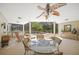 Inviting sunroom features a glass table, rocking chair, and views of the screened-in pool area at 7343 Palomino Trl, Sarasota, FL 34241