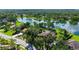 Aerial view of home surrounded by mature trees next to a pond at 7426 Weeping Willow Blvd, Sarasota, FL 34241