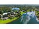 Expansive aerial view of a waterside home, highlighting its beautiful landscaping and lakefront location at 7426 Weeping Willow Blvd, Sarasota, FL 34241