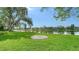 Well-manicured lawn leading to a tranquil lake provides a serene outdoor escape and natural beauty at 7426 Weeping Willow Blvd, Sarasota, FL 34241