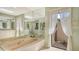 Relaxing bathroom features tile flooring, tub, a skylight, and access to a private outdoor area at 7426 Weeping Willow Blvd, Sarasota, FL 34241