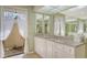 Bathroom vanity features granite counters, dual sinks, and views to the fenced outdoor area at 7426 Weeping Willow Blvd, Sarasota, FL 34241