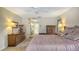 Comfortable bedroom with ensuite bathroom has carpet flooring, neutral paint and wallpaper, and a large bed frame at 7426 Weeping Willow Blvd, Sarasota, FL 34241