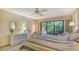 Bright and airy bedroom with an outdoor view and a light color scheme for a relaxed and inviting ambiance at 7426 Weeping Willow Blvd, Sarasota, FL 34241