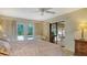 Cozy bedroom features access to a covered patio and pool area via sliding glass doors for seamless indoor-outdoor experience at 7426 Weeping Willow Blvd, Sarasota, FL 34241