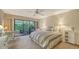 Bright bedroom with a large window showcasing lush greenery, creating a peaceful and private retreat at 7426 Weeping Willow Blvd, Sarasota, FL 34241
