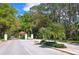 Gated entry to the community with lush landscaping along the street at 7426 Weeping Willow Blvd, Sarasota, FL 34241