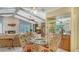 Dining room with beamed ceilings, tiled floor, fireplace, and adjacent built-in bar is great for gatherings and entertaining at 7426 Weeping Willow Blvd, Sarasota, FL 34241