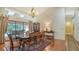 Elegant dining room featuring a grand chandelier, large windows, and access to outdoor living space at 7426 Weeping Willow Blvd, Sarasota, FL 34241
