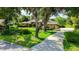 Charming single-story home featuring a lush front yard, mature trees, and a welcoming driveway at 7426 Weeping Willow Blvd, Sarasota, FL 34241
