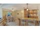 An open kitchen with custom cabinetry, granite counters, tile flooring, and adjacent breakfast nook offer inviting home at 7426 Weeping Willow Blvd, Sarasota, FL 34241