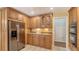 An efficient kitchen layout features modern stainless steel appliances, granite counters and custom cabinets with ample storage at 7426 Weeping Willow Blvd, Sarasota, FL 34241