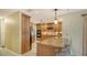Custom kitchen features wood cabinets, granite counters, stainless appliances and a breakfast bar with stylish pendant lighting at 7426 Weeping Willow Blvd, Sarasota, FL 34241