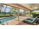 Relaxing screened-in lanai with a pool and lake view, ideal for outdoor relaxation and entertainment at 7426 Weeping Willow Blvd, Sarasota, FL 34241