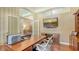 Spacious home office with built-in desk, shelving, and media center for a functional workspace at 7426 Weeping Willow Blvd, Sarasota, FL 34241