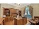 Office with custom built-ins, hardwood floors, crown molding and large window providing natural light at 7426 Weeping Willow Blvd, Sarasota, FL 34241