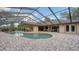 Enjoy outdoor living with the screened-in pool, featuring a brick patio and access to the home's exterior at 7426 Weeping Willow Blvd, Sarasota, FL 34241