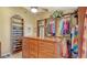 Custom walk-in closet featuring wood shelving, drawers, and an island dresser at 7426 Weeping Willow Blvd, Sarasota, FL 34241