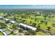 Beautiful aerial view of community condo on a golf course with lush landscaping and a pristine waterway at 7461 W Country Club N Dr # 206, Sarasota, FL 34243