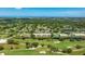 Aerial view of building surrounded by a lush green golf course and a blue body of water at 7461 W Country Club N Dr # 206, Sarasota, FL 34243