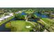 Stunning aerial view of a lush golf course community with waterways surrounding pristine greens at 7461 W Country Club N Dr # 206, Sarasota, FL 34243